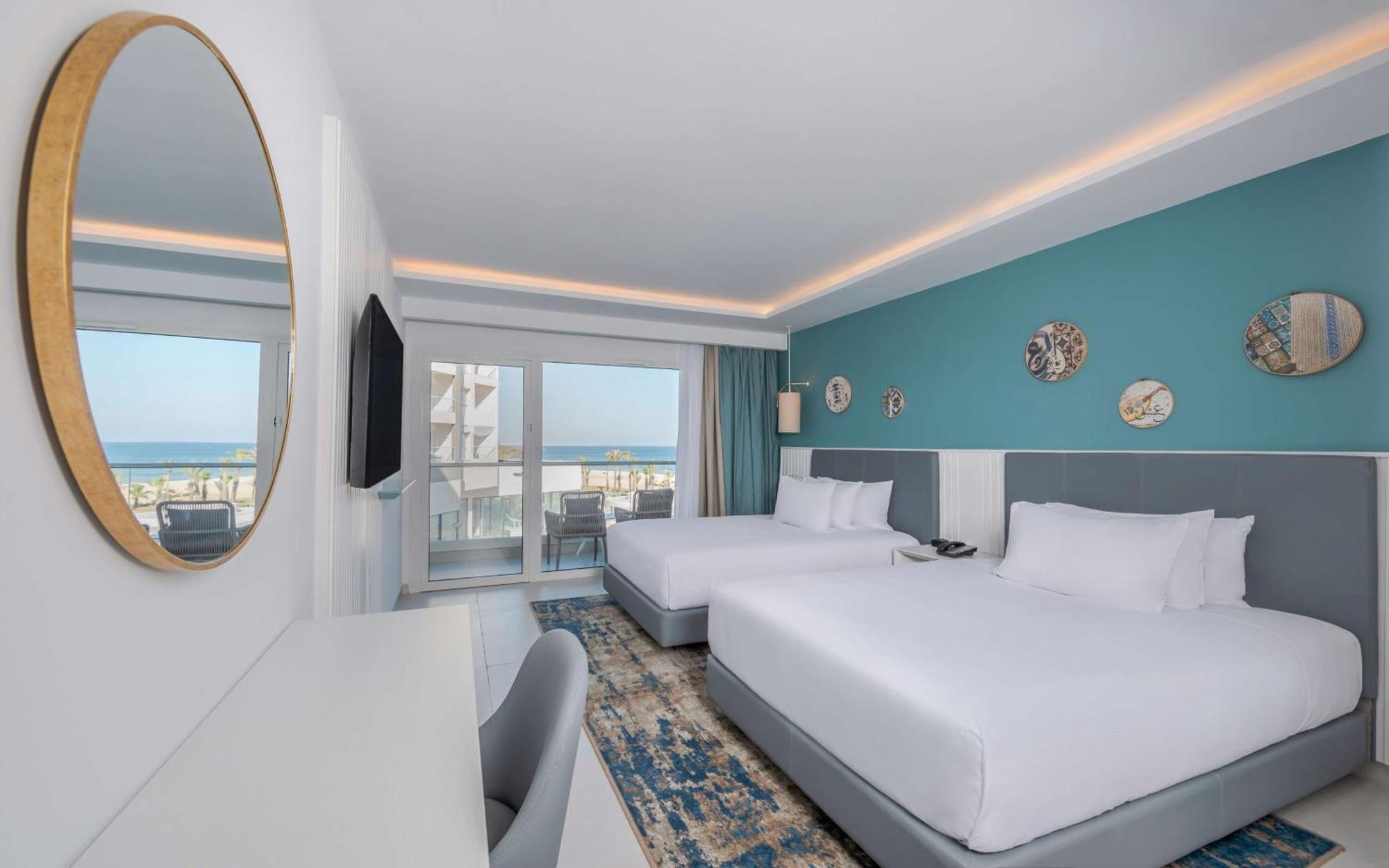 One-Bedroom Queen Suite with Two Queen Beds and Partial Sea View